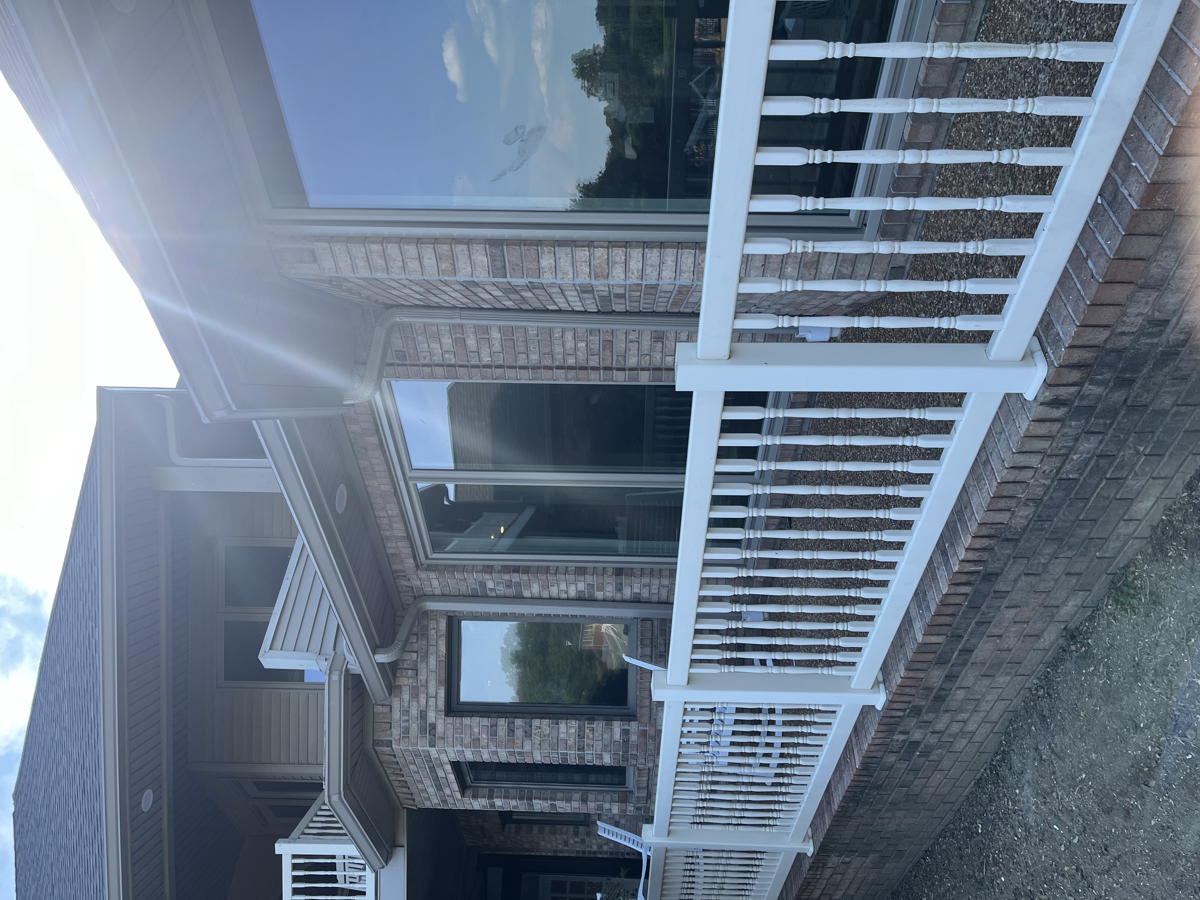 large back patio with custom vinyl porch railings