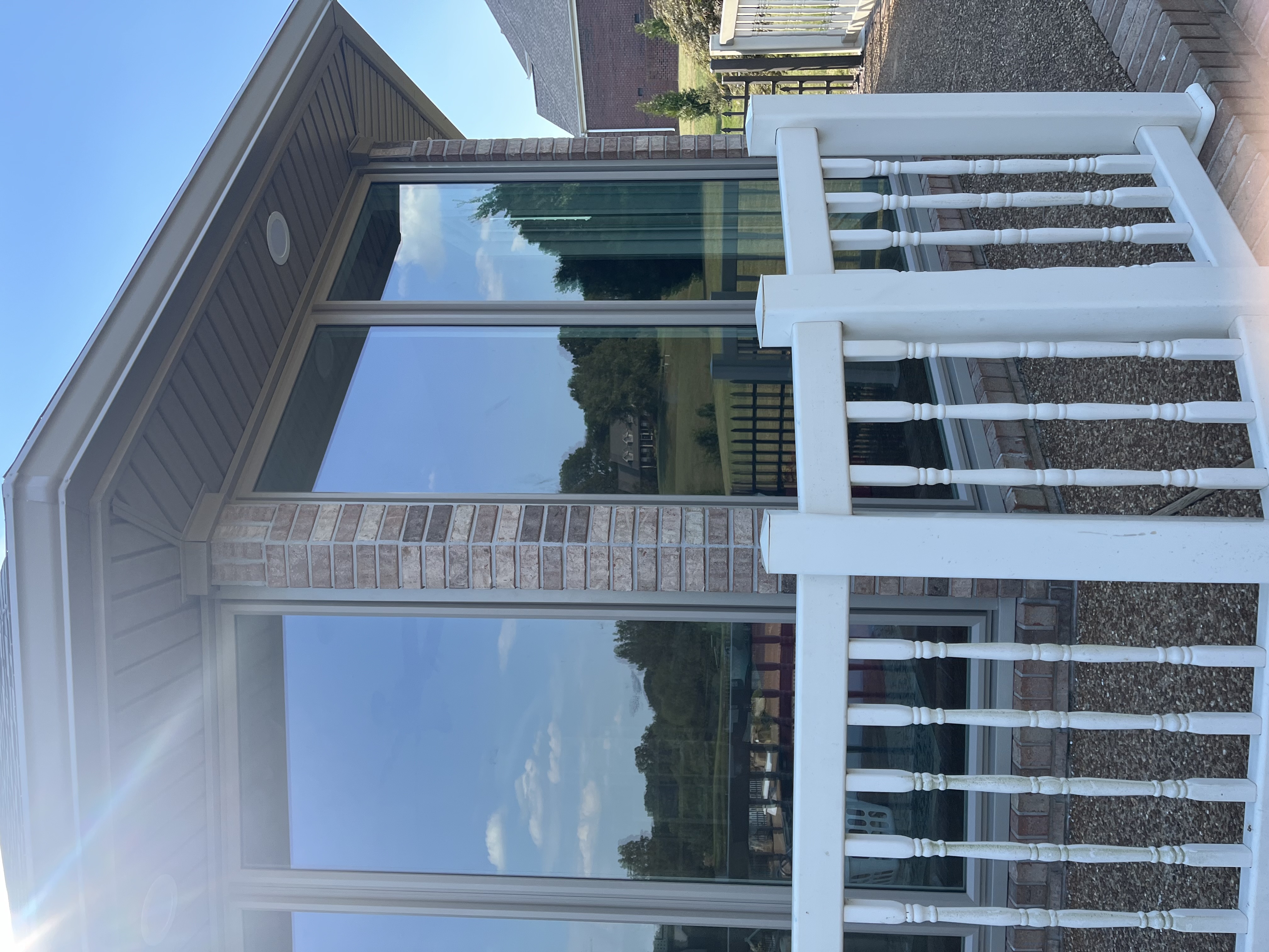 custom windows and vinyl porch rails on home