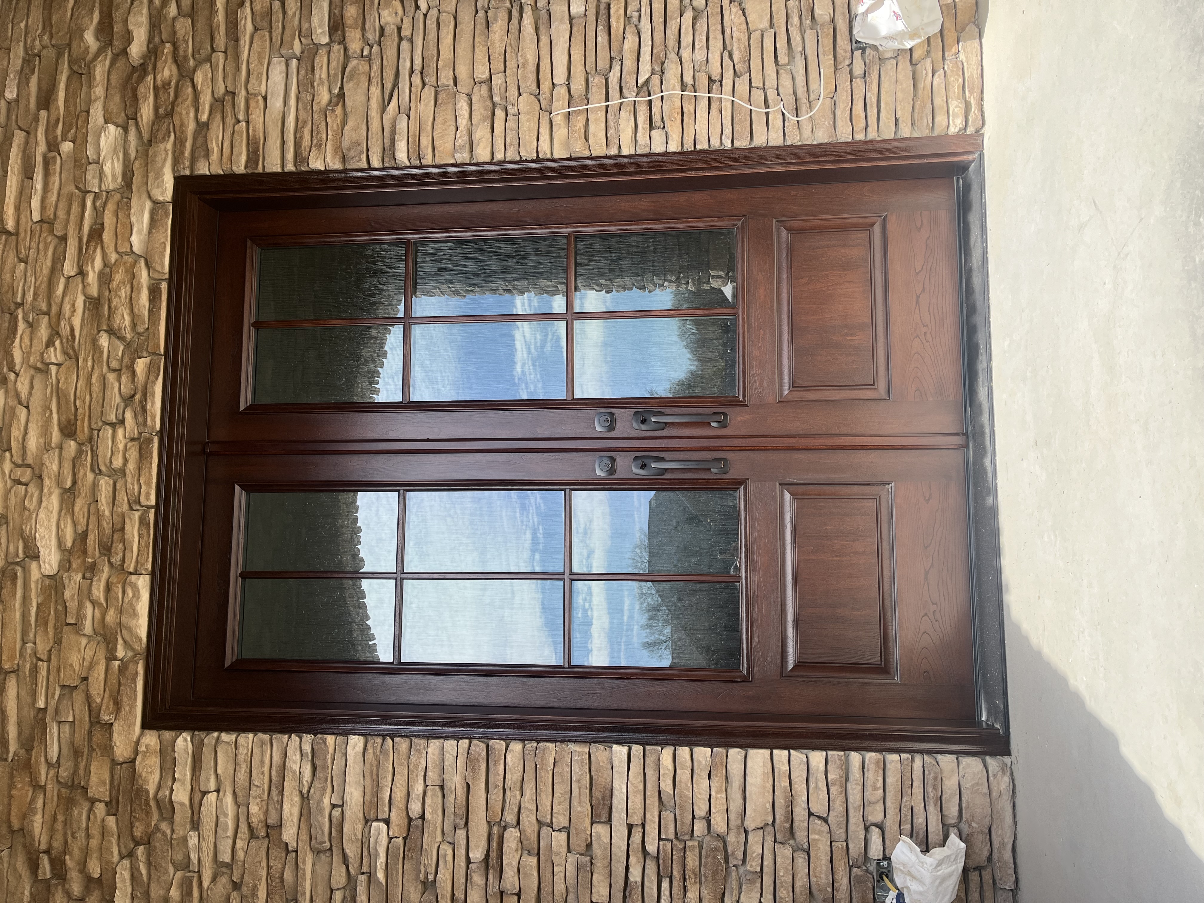 double wooden front door with large windows