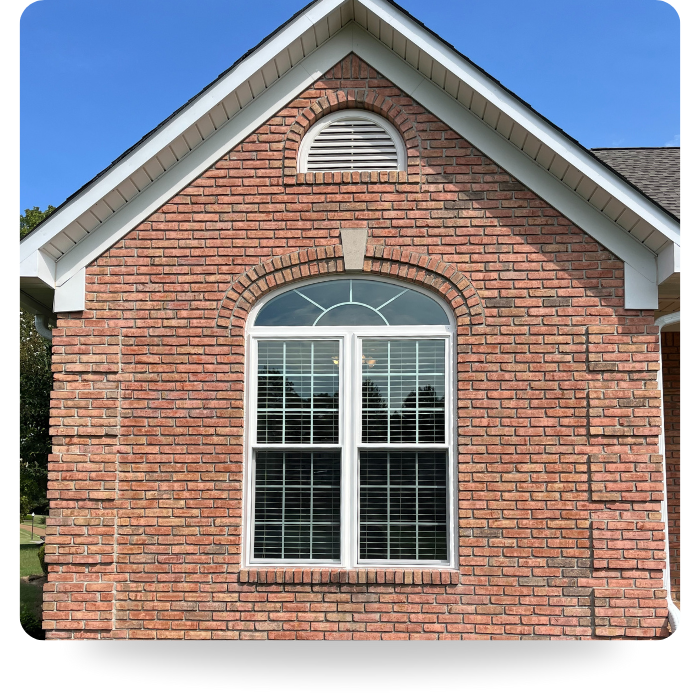 custom arched window on brick home