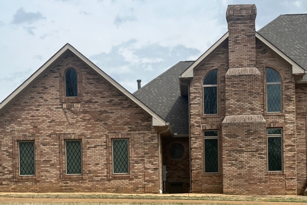 large brick home with custom windows